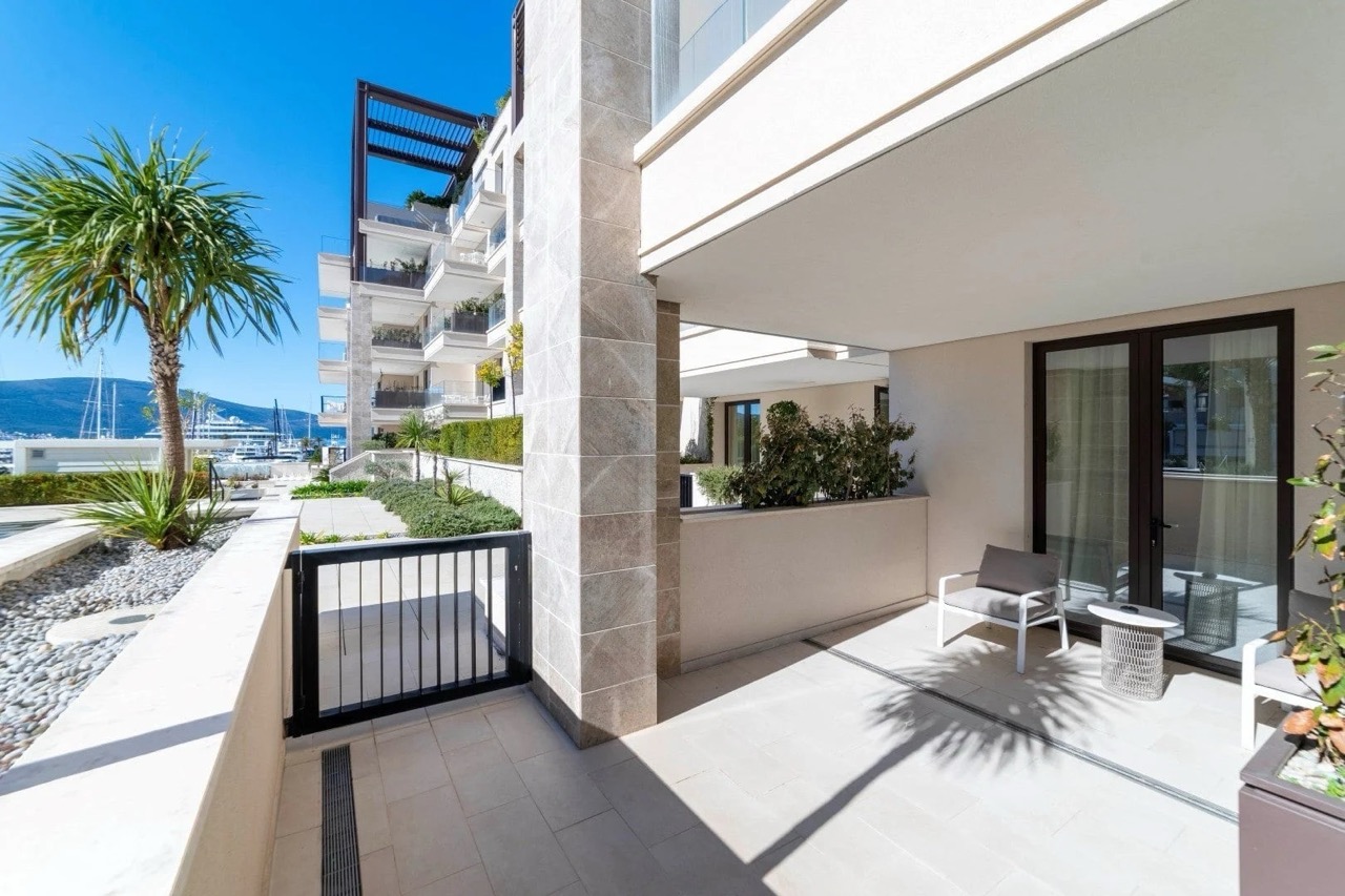 Terrace of a luxury apartment in Porto Montenegro, Tivat, Montenegro: marina view, modern furniture, and stone finishes.