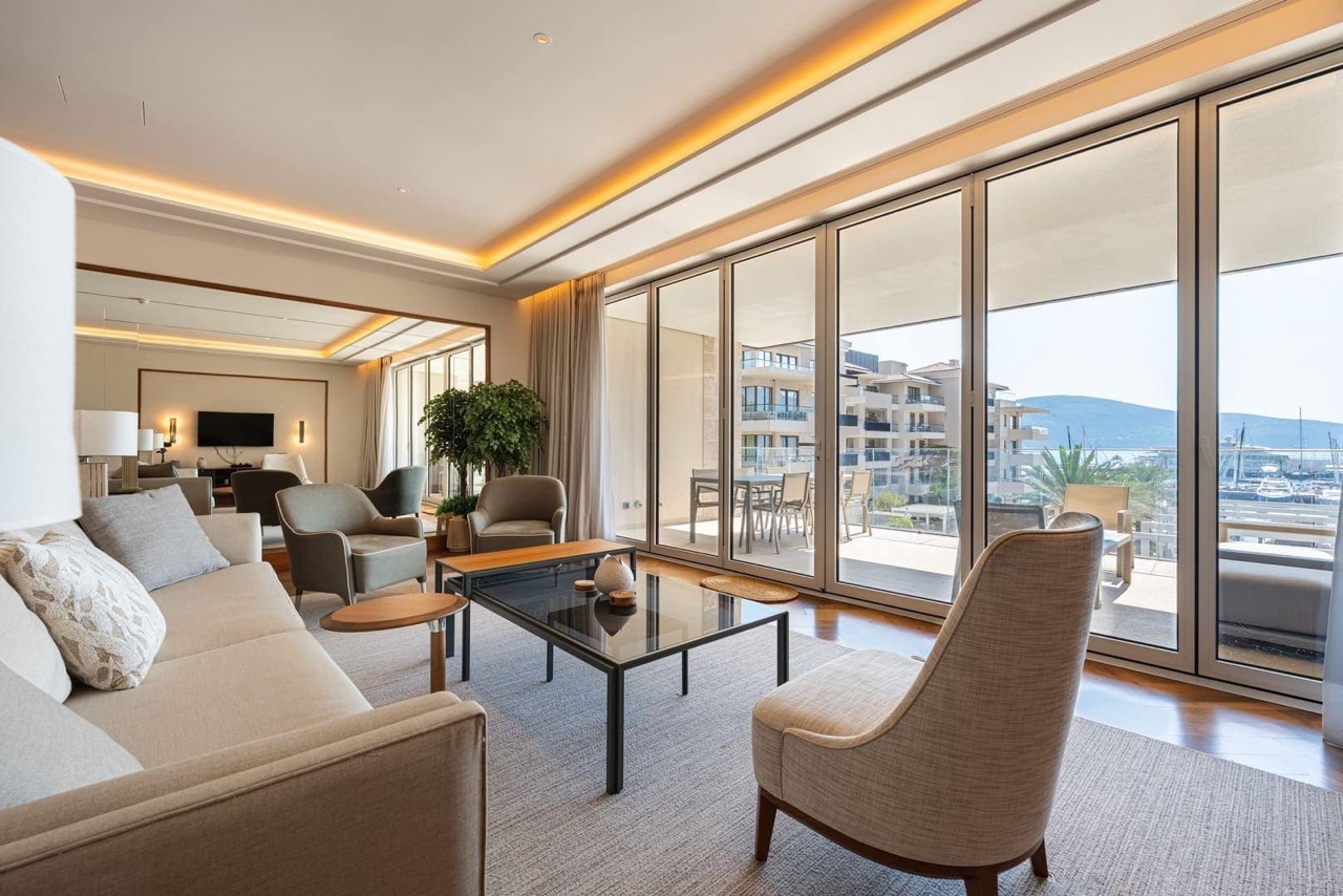Living room with panoramic windows and a view of the marina in the luxury Porto Montenegro residential complex, Tivat, Montenegro.