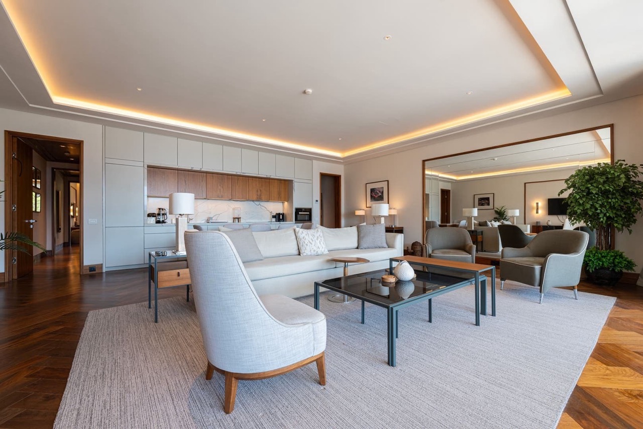 Modern living room with kitchen in an apartment in Porto Montenegro, Tivat, Montenegro: stylish furniture and parquet flooring.