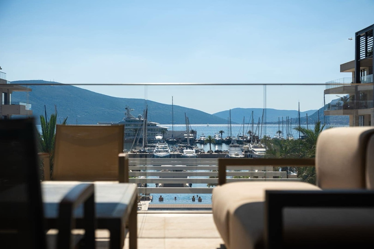 View from the apartment terrace in Porto Montenegro, Tivat, Montenegro: panoramic view of the yacht marina and mountains.