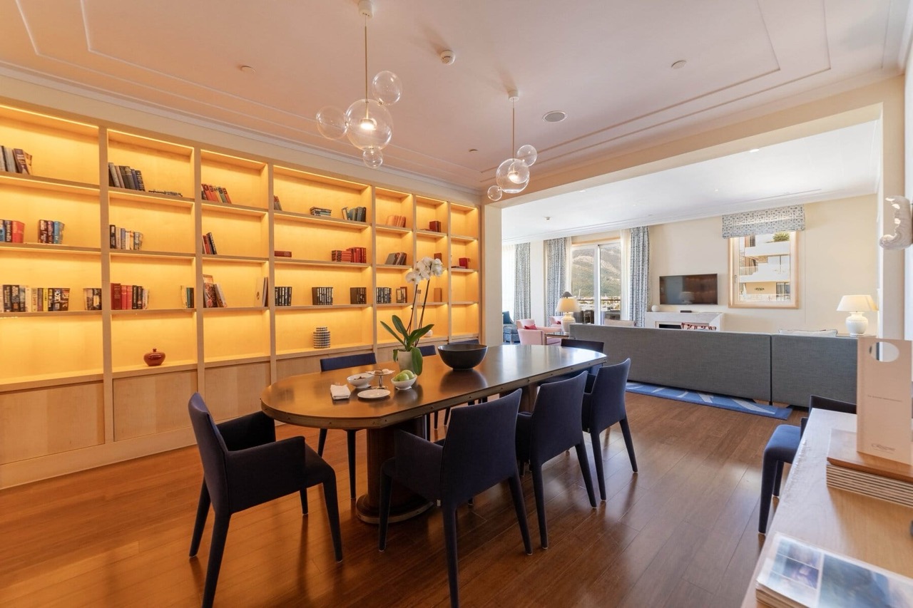 Dining area with a library in a luxury apartment in Porto Montenegro, Tivat, Montenegro: modern interior and furniture.