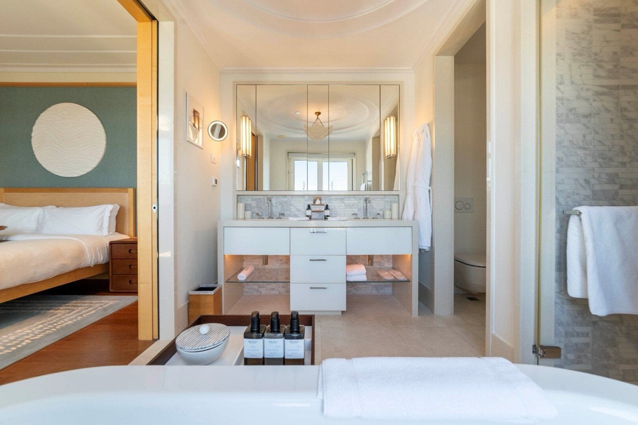 Modern bathroom in an apartment in Porto Montenegro, Tivat, Montenegro: marble finishes and a view of the bedroom.