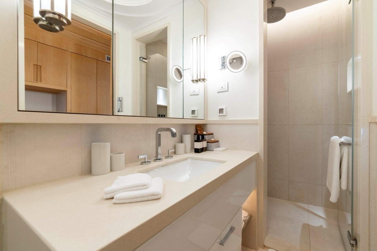 Modern bathroom with a shower in an apartment in Porto Montenegro, Tivat, Montenegro: light finishes and stylish furniture.