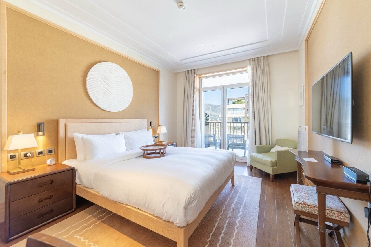 Cozy bedroom in Porto Montenegro, Tivat, Montenegro: double bed, balcony with a view, and stylish interior.