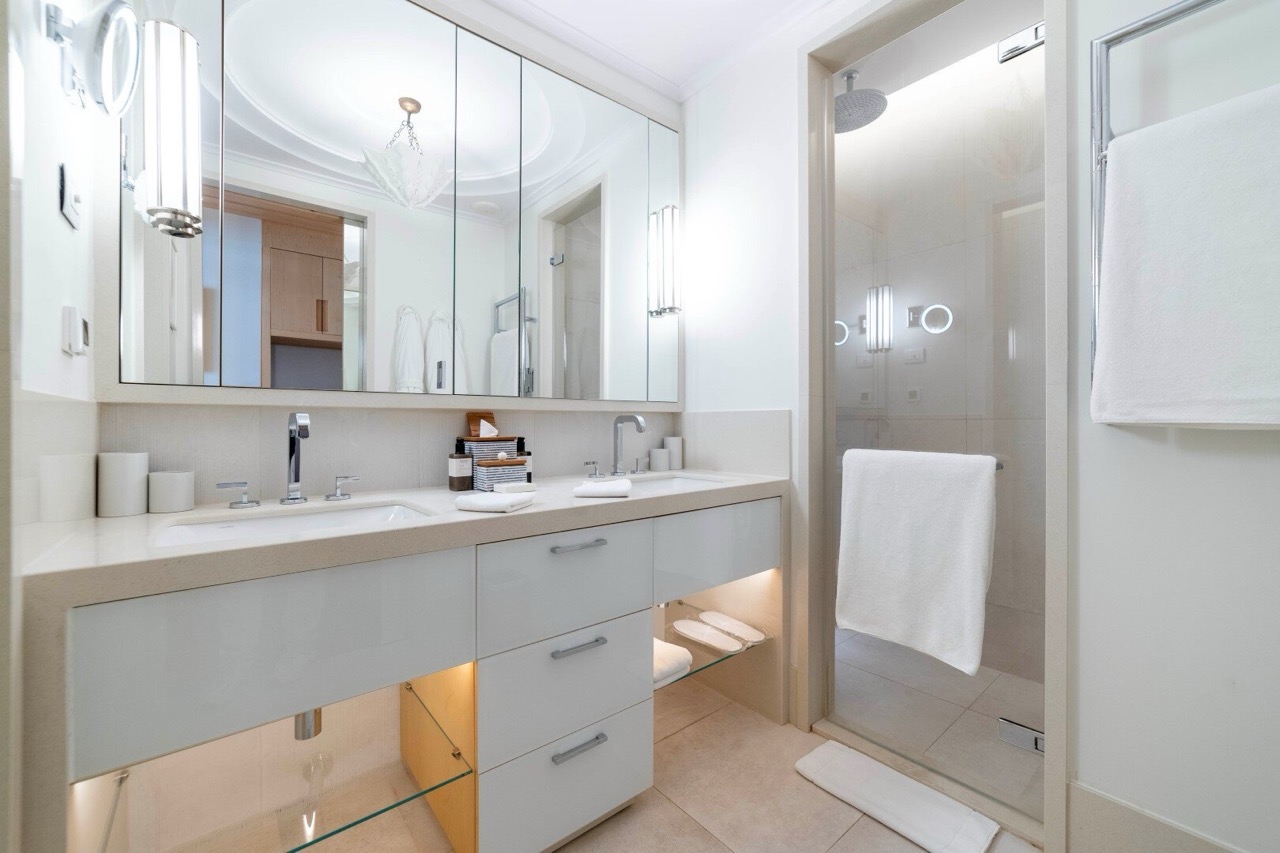 Modern bathroom with two sinks and a shower cabin in an apartment in Porto Montenegro, Tivat, Montenegro.