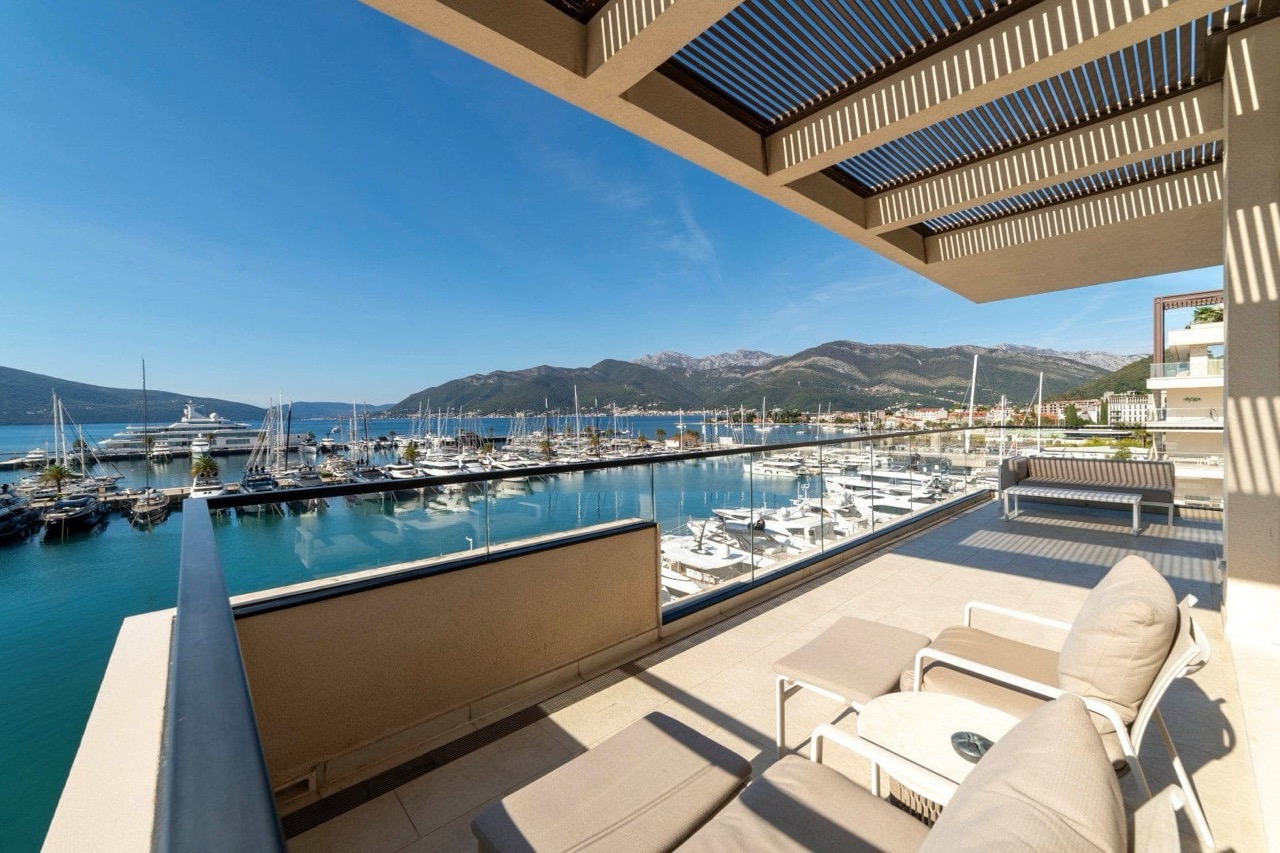 Apartment terrace in Porto Montenegro, Tivat: marina view with yachts, modern furniture and canopy, Montenegro.