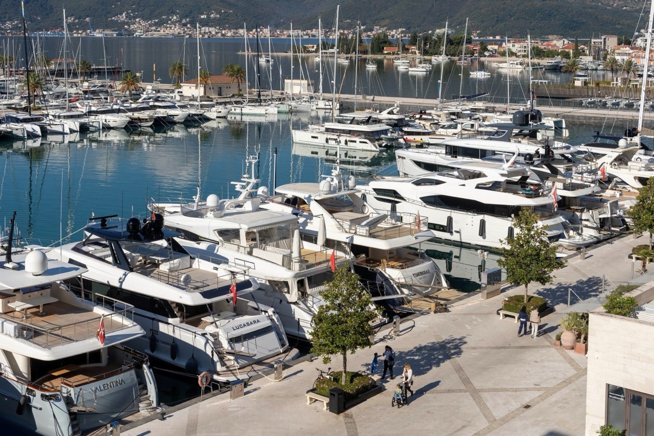 View of the luxury marina with yachts in Porto Montenegro, Tivat, Montenegro: the waterfront promenade and dock for luxury vessels.