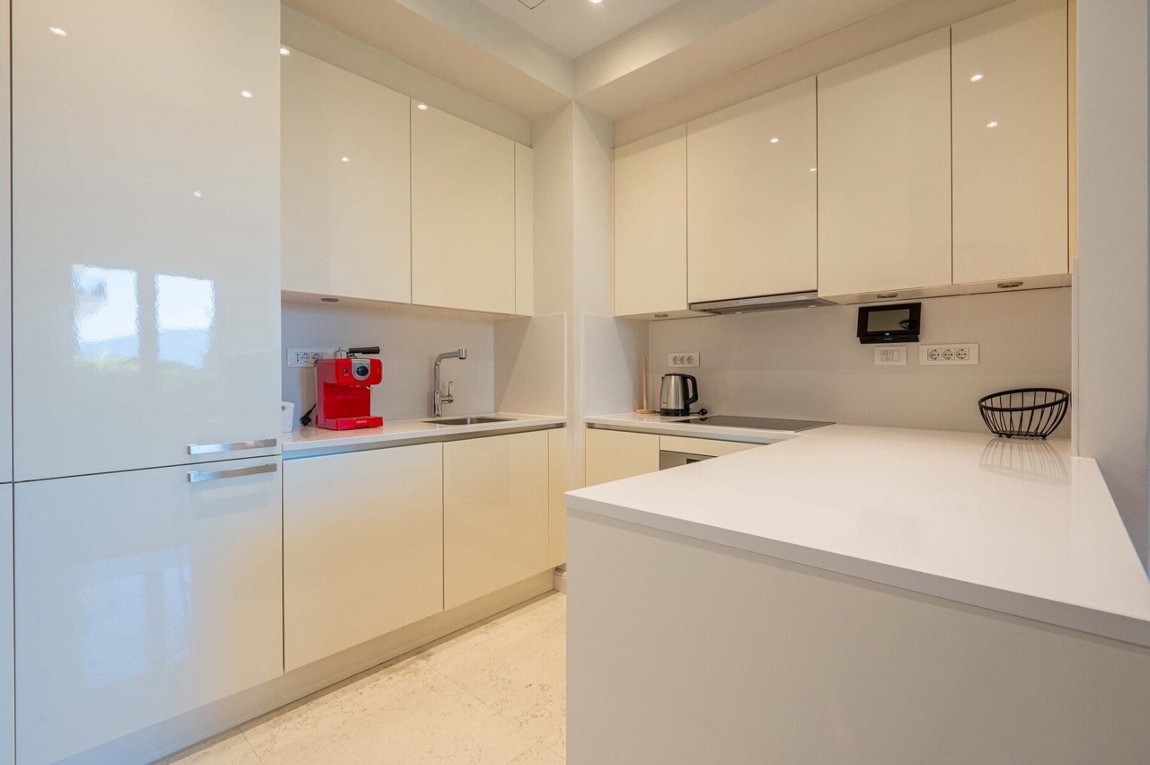 Modern bright kitchen with glossy fronts in an apartment in Porto Montenegro, Tivat, Montenegro.