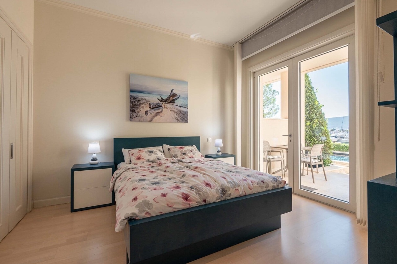 Bedroom in an apartment in Porto Montenegro, Tivat, Montenegro: double bed, access to a terrace overlooking the marina.
