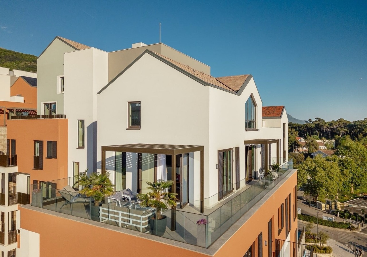 Modern apartment with a terrace in Porto Montenegro, Tivat, Montenegro: view of the building facade and lounge area.