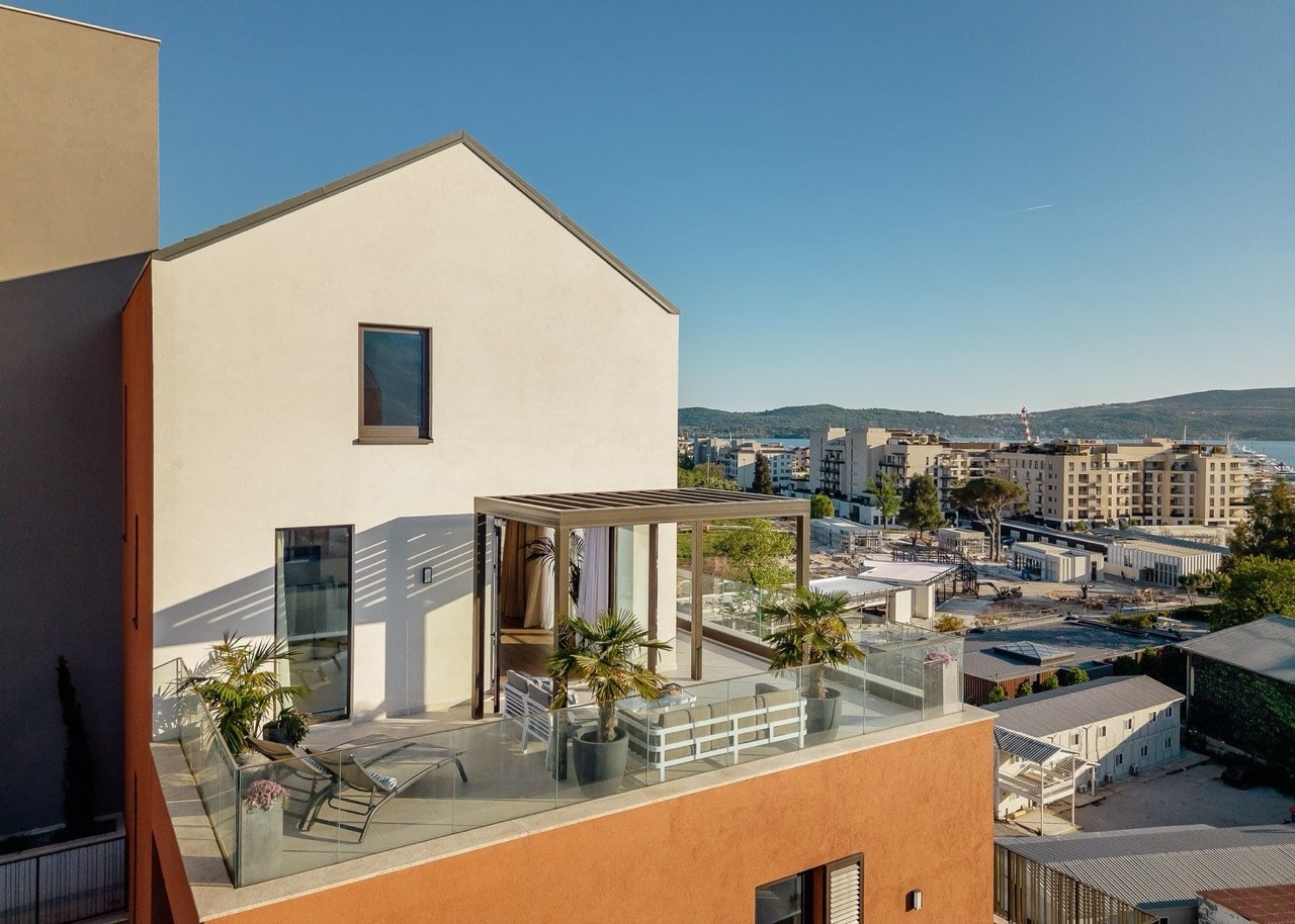 Apartment terrace in Porto Montenegro, Tivat, Montenegro: modern furniture, pergola, and city and sea view.