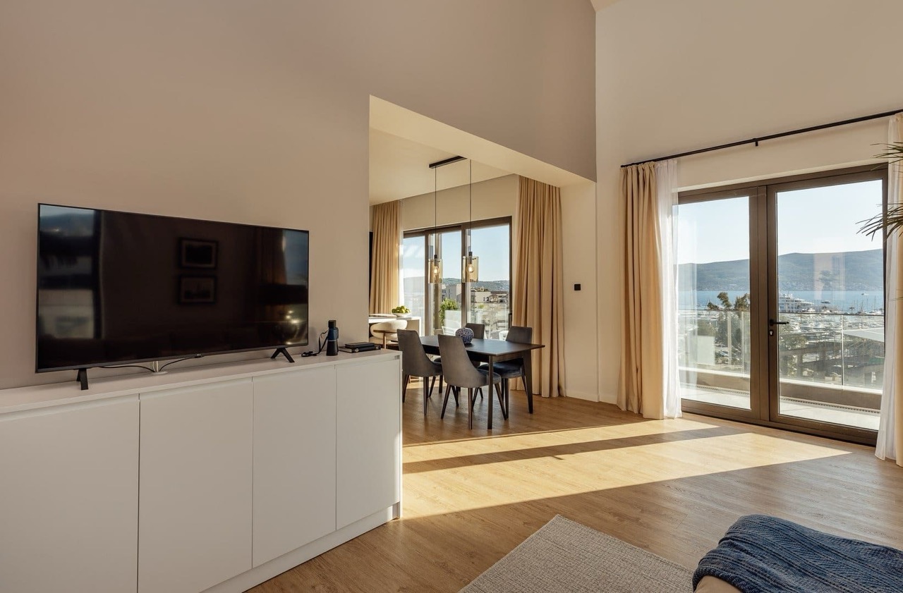 Living room with a view of the marina in an apartment in Porto Montenegro, Tivat, Montenegro: modern interior, dining area.