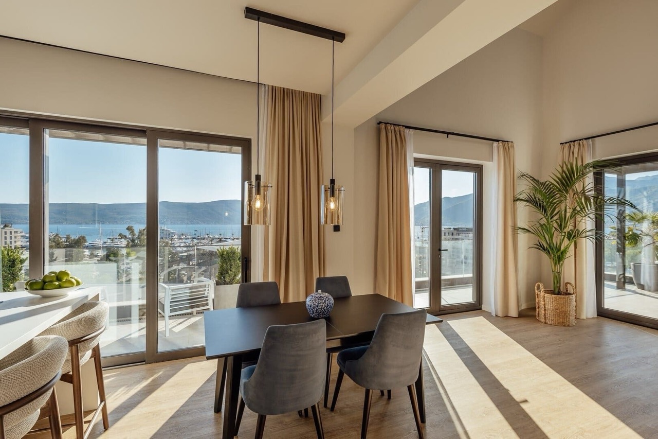 Living room with dining area in an apartment in Porto Montenegro, Tivat, Montenegro: marina view and modern interiors.