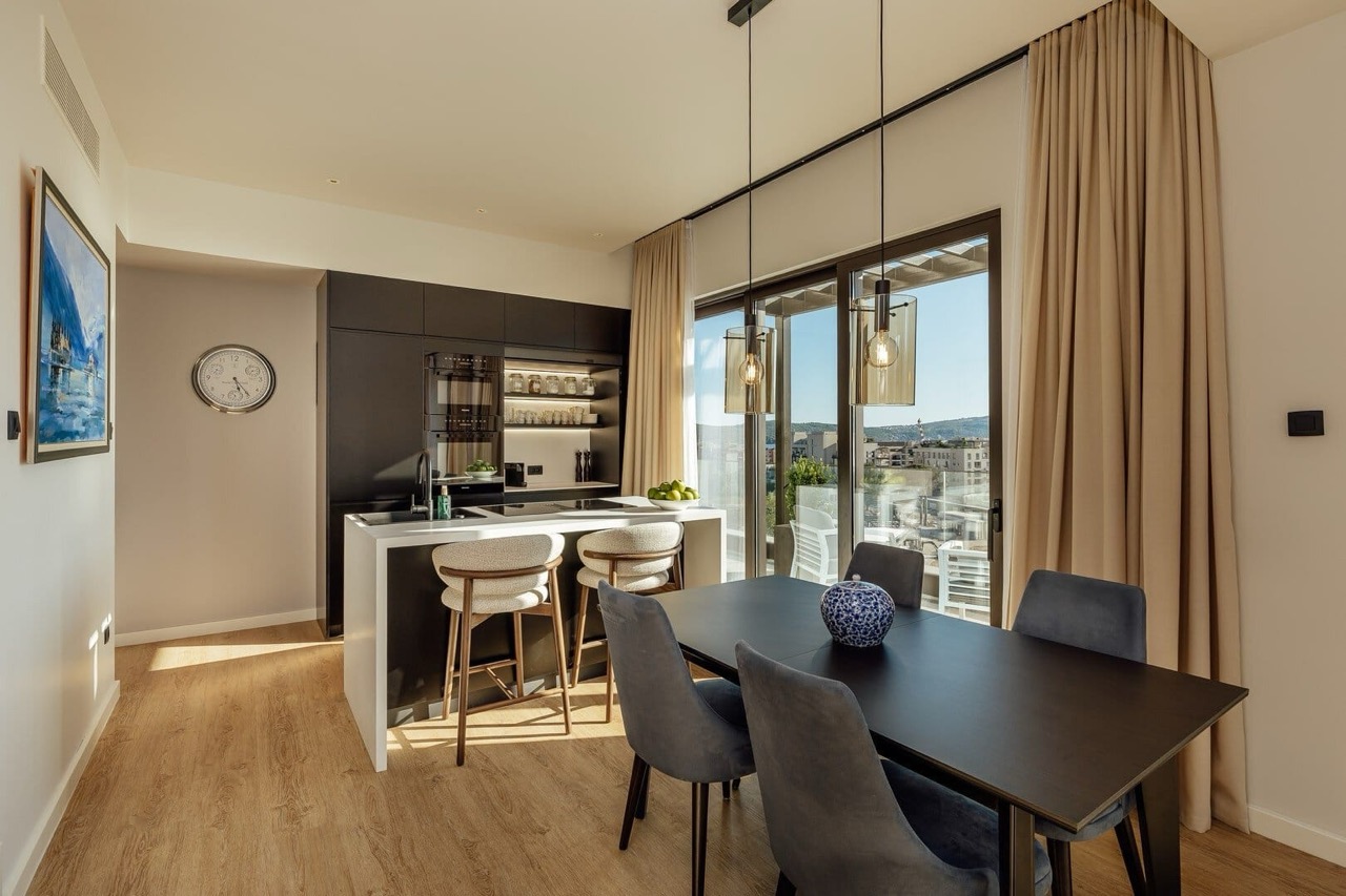 Modern kitchen-dining room in an apartment in Porto Montenegro, Tivat, Montenegro, with panoramic views and stylish furniture.