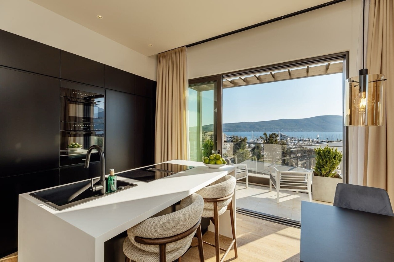 Modern kitchen with an island in an apartment in Porto Montenegro, Tivat, Montenegro, with panoramic views of the yacht marina.