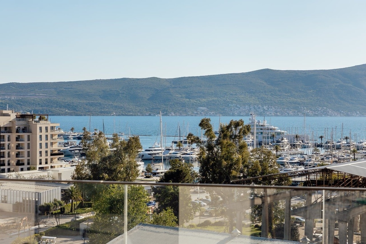 View from the apartment balcony in Porto Montenegro, Tivat, Montenegro: panoramic view of the yacht marina and mountains.