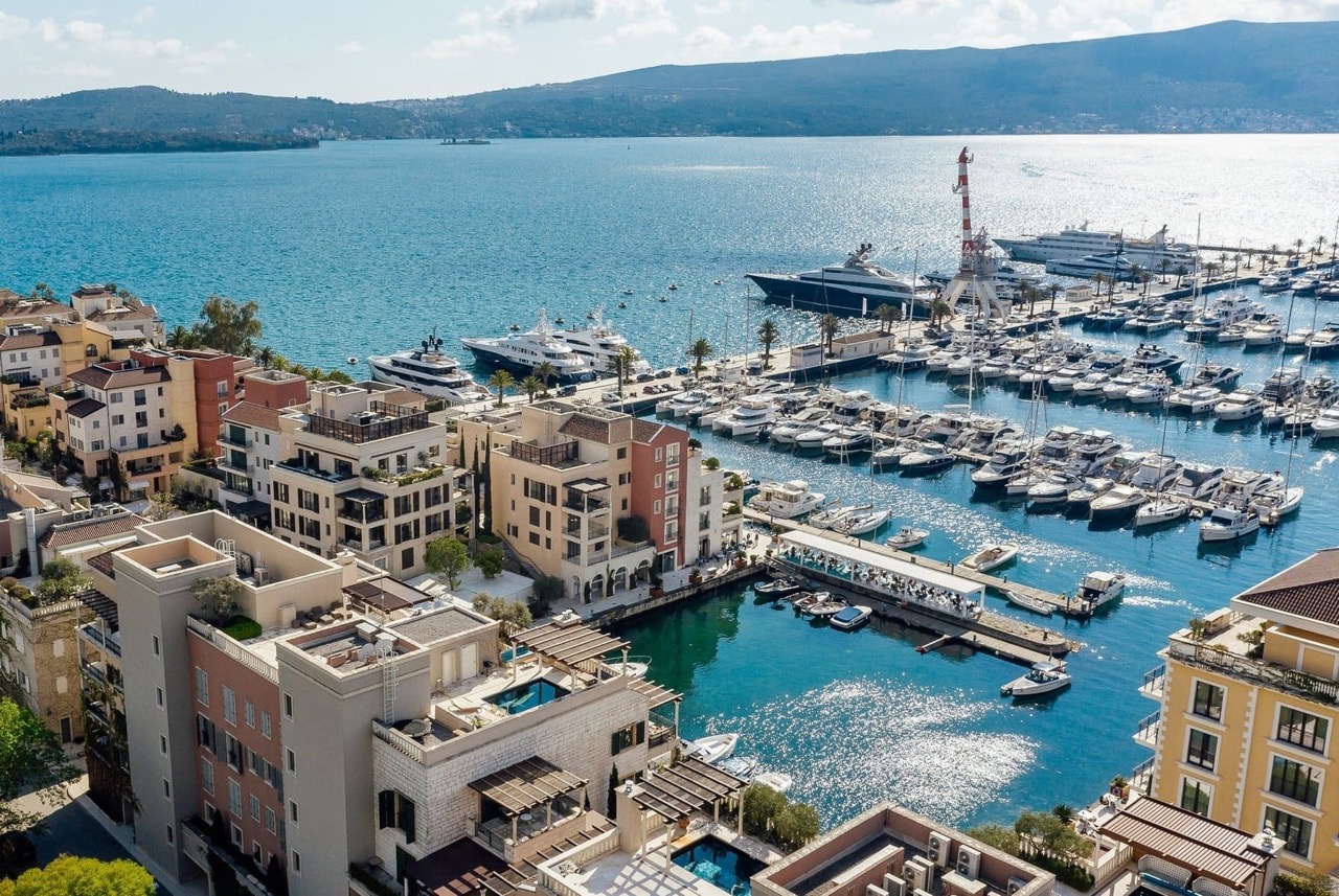 Aerial view of the luxury Porto Montenegro residential complex in Tivat, Montenegro, with a private marina and yachts.
