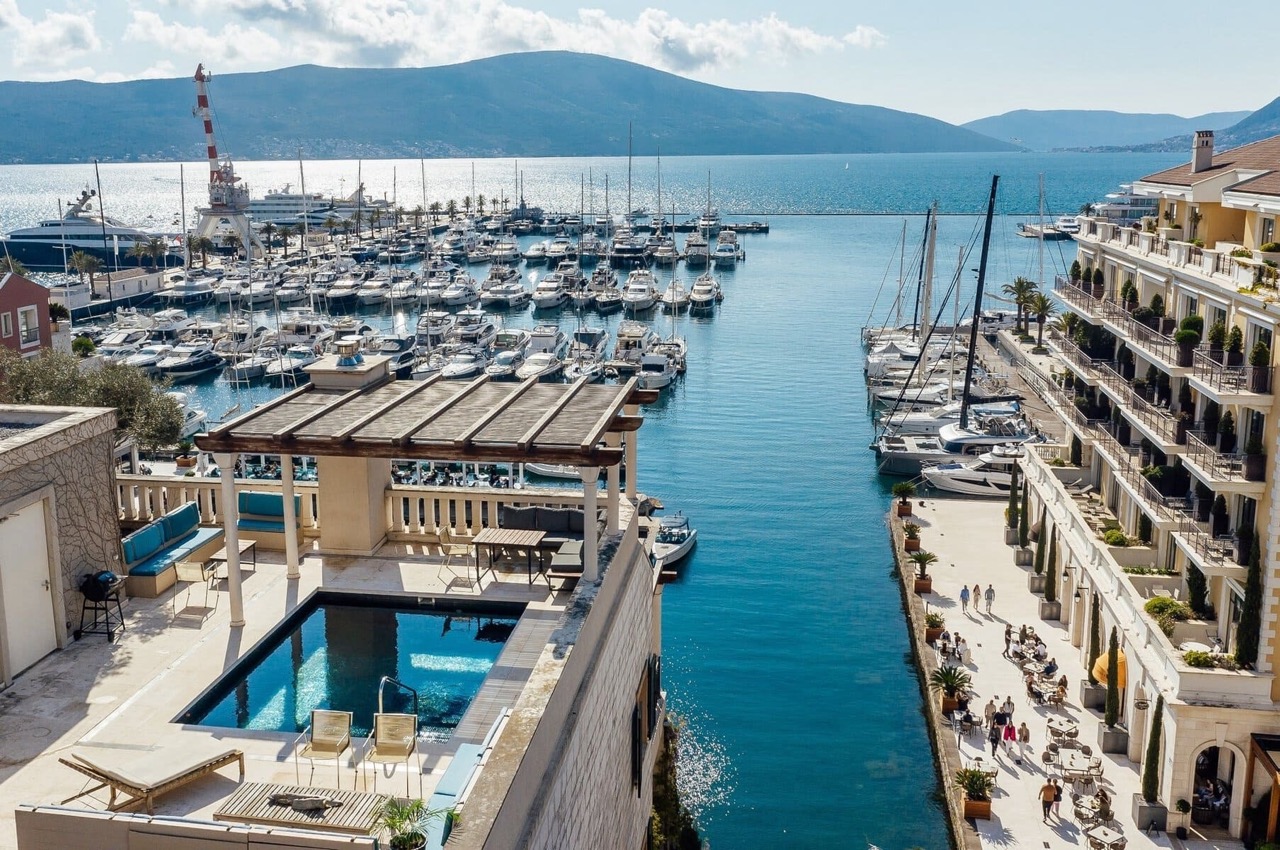 View of the pool on the terrace and the Porto Montenegro yacht marina, Tivat, Montenegro: luxury seaside property.
