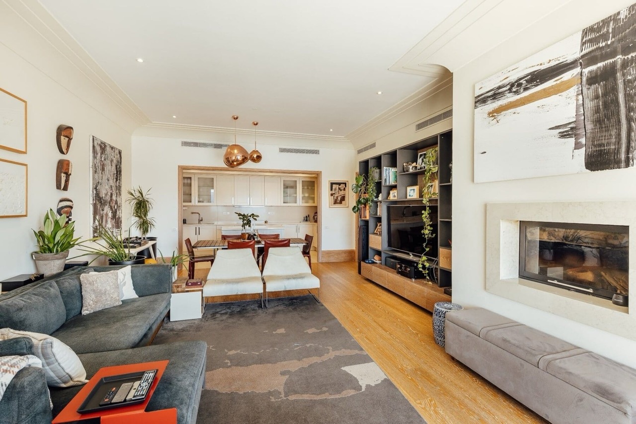 Modern living room with fireplace and kitchen in an apartment, Porto Montenegro, Tivat, Montenegro: stylish interior with furniture.