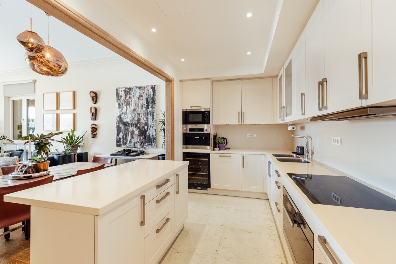 Modern bright kitchen with an island in an apartment in Porto Montenegro, Tivat, Montenegro: built-in appliances and design.