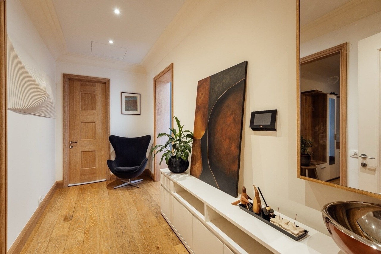 Stylish hallway interior in an apartment in Porto Montenegro, Tivat, Montenegro: wooden floor, decor, and furniture.