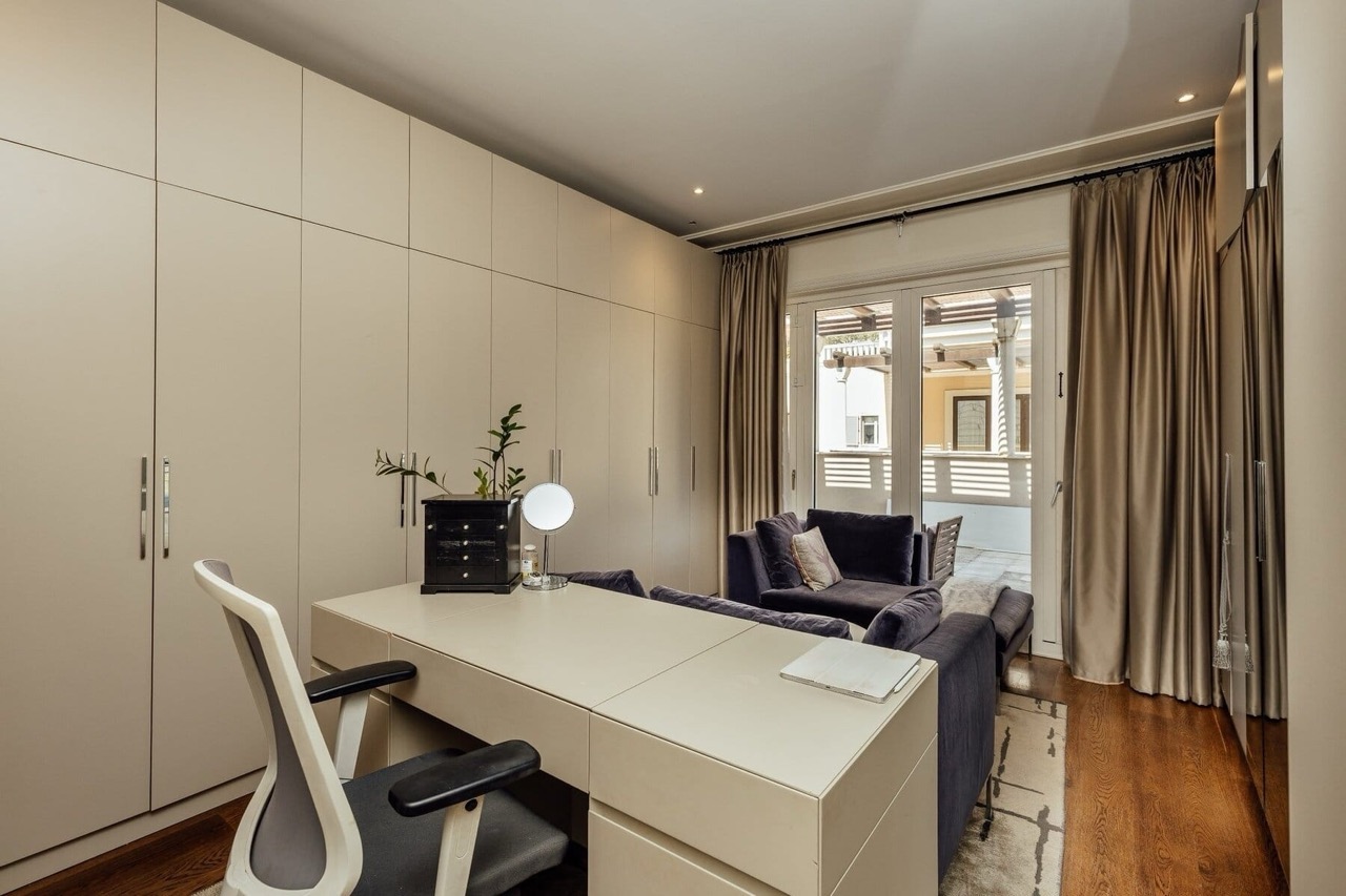 Modern living room with a desk and access to the terrace in Porto Montenegro apartments, Tivat, Montenegro.