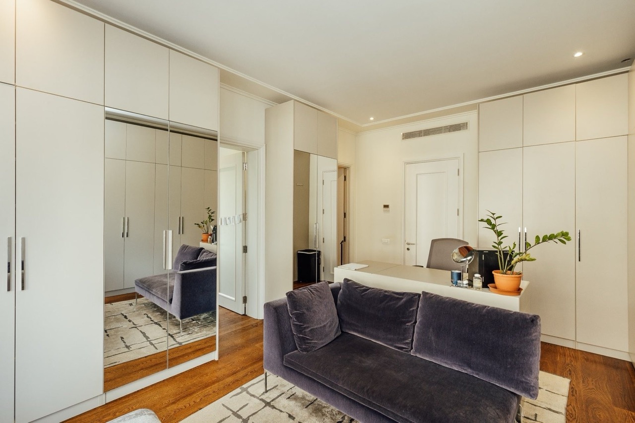 Living room with a gray sofa and built-in cabinets in an apartment in Porto Montenegro, Tivat, Montenegro.