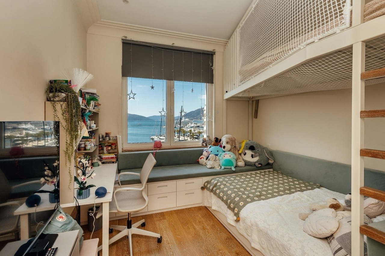 Children’s bedroom with a bunk bed and a view of the marina in Porto Montenegro, Tivat, Montenegro.