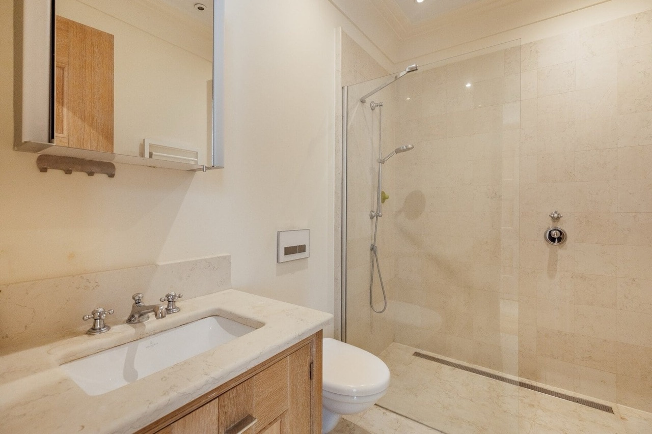 Modern bathroom with a shower cabin and stone finishes in an apartment in Porto Montenegro, Tivat, Montenegro.