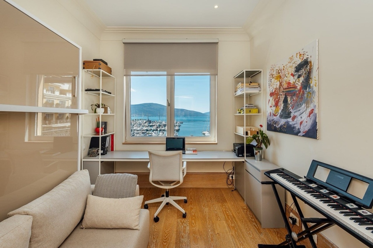 Home office in an apartment in Porto Montenegro, Tivat, Montenegro, with a marina view, a desk, and a keyboard.