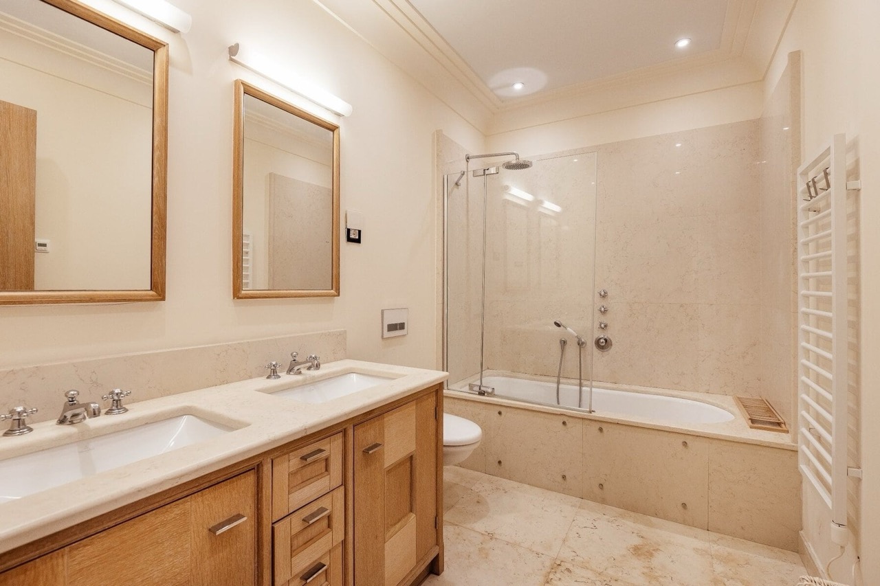 Modern bathroom with light stone finishes in an apartment in Porto Montenegro, Tivat, Montenegro.