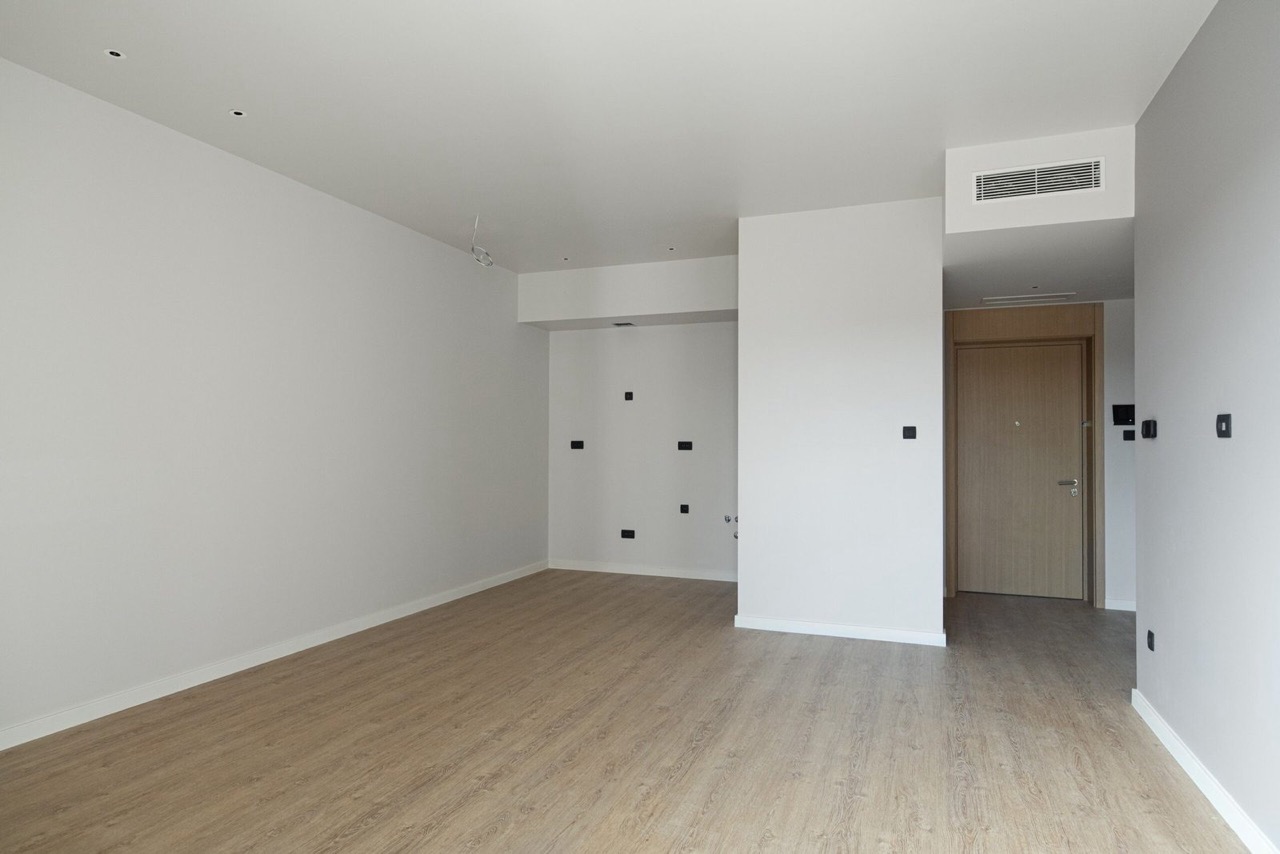 Bright living room with wood-style finishes in an apartment in Porto Montenegro, Tivat, Montenegro. Modern interior.