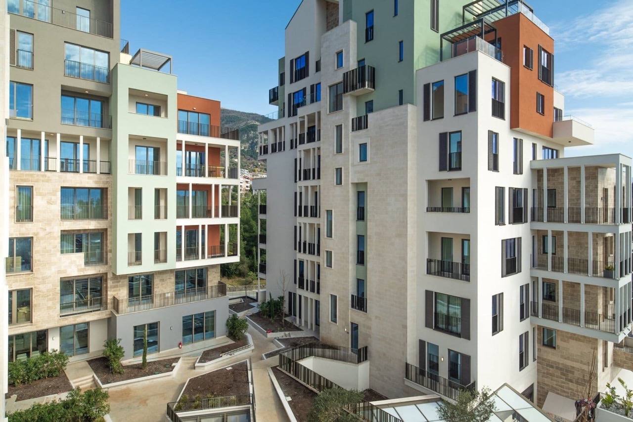 Modern residential complex in Porto Montenegro, Tivat, Montenegro: view of the building facades with terraces and landscaping.
