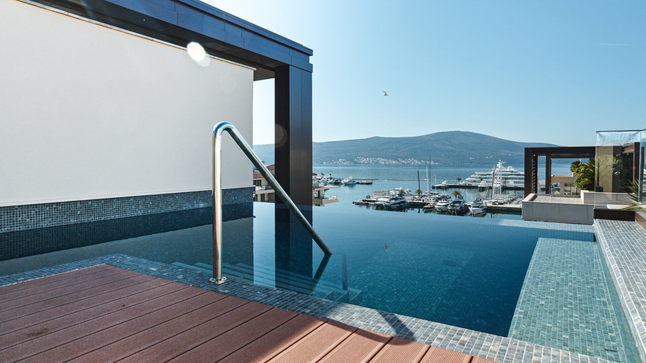 Infinity pool on the terrace of a luxury apartment in Porto Montenegro, Tivat, overlooking the marina and yachts, Montenegro.