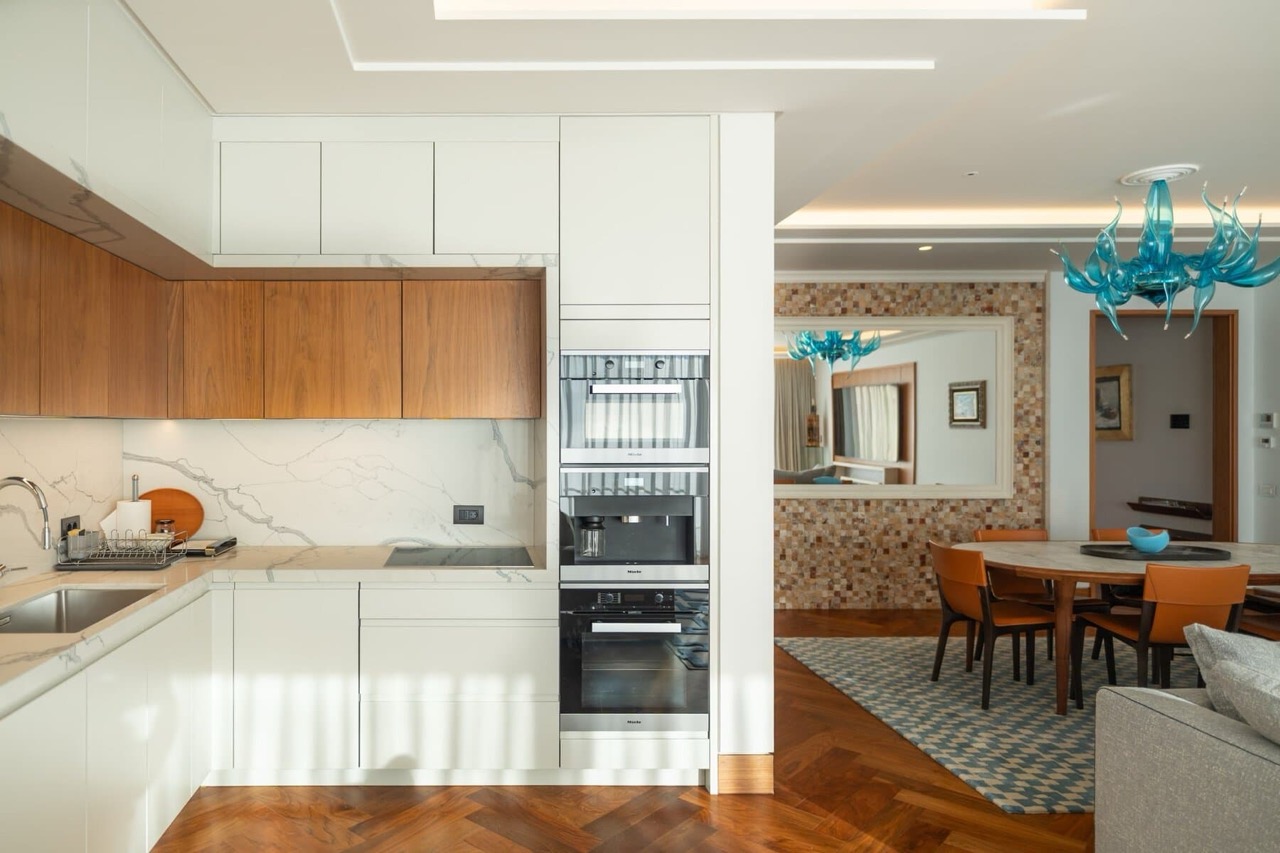 Modern kitchen with Miele appliances in an apartment in Porto Montenegro, Tivat, Montenegro: marble backsplash and dining area.