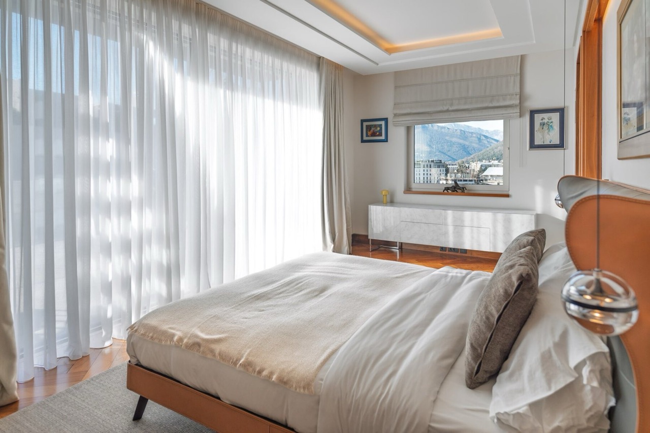 Modern bedroom in Porto Montenegro, Tivat, Montenegro: panoramic windows, mountain view, designer furniture and finishes.
