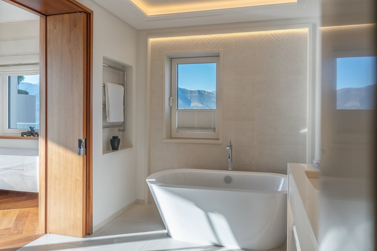 Modern bathroom in an apartment in Porto Montenegro, Tivat, Montenegro: freestanding bathtub and mountain view.