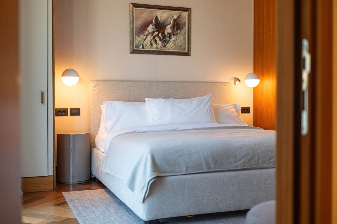 Modern bedroom with a double bed in an apartment, Porto Montenegro, Tivat, Montenegro: stylish interior.