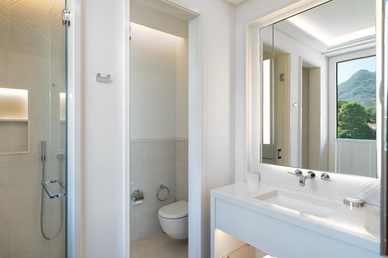 Modern bathroom in an apartment in Porto Montenegro, Tivat, Montenegro: shower, stylish fixtures, and mountain view.