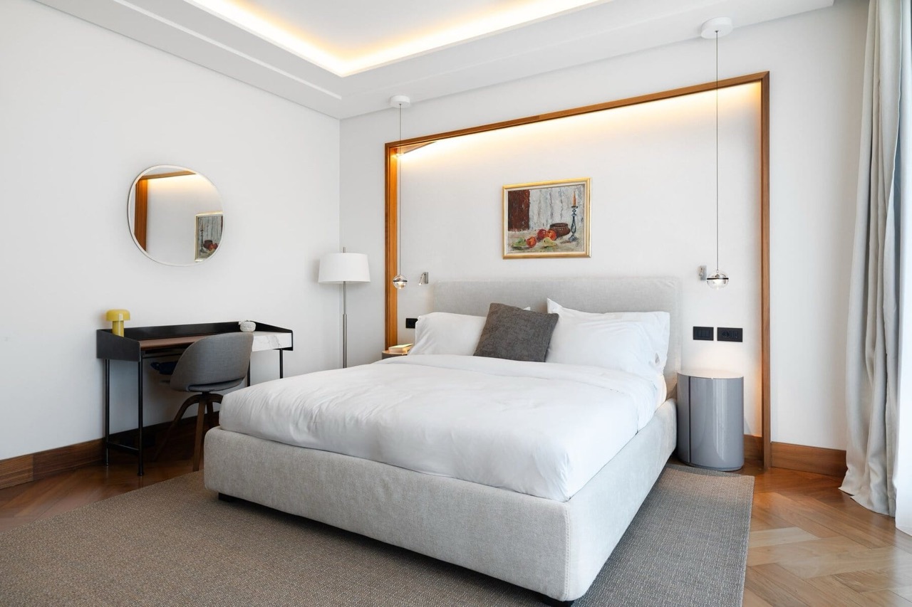 Modern bedroom with a double bed and a desk in Porto Montenegro apartments, Tivat, Montenegro.