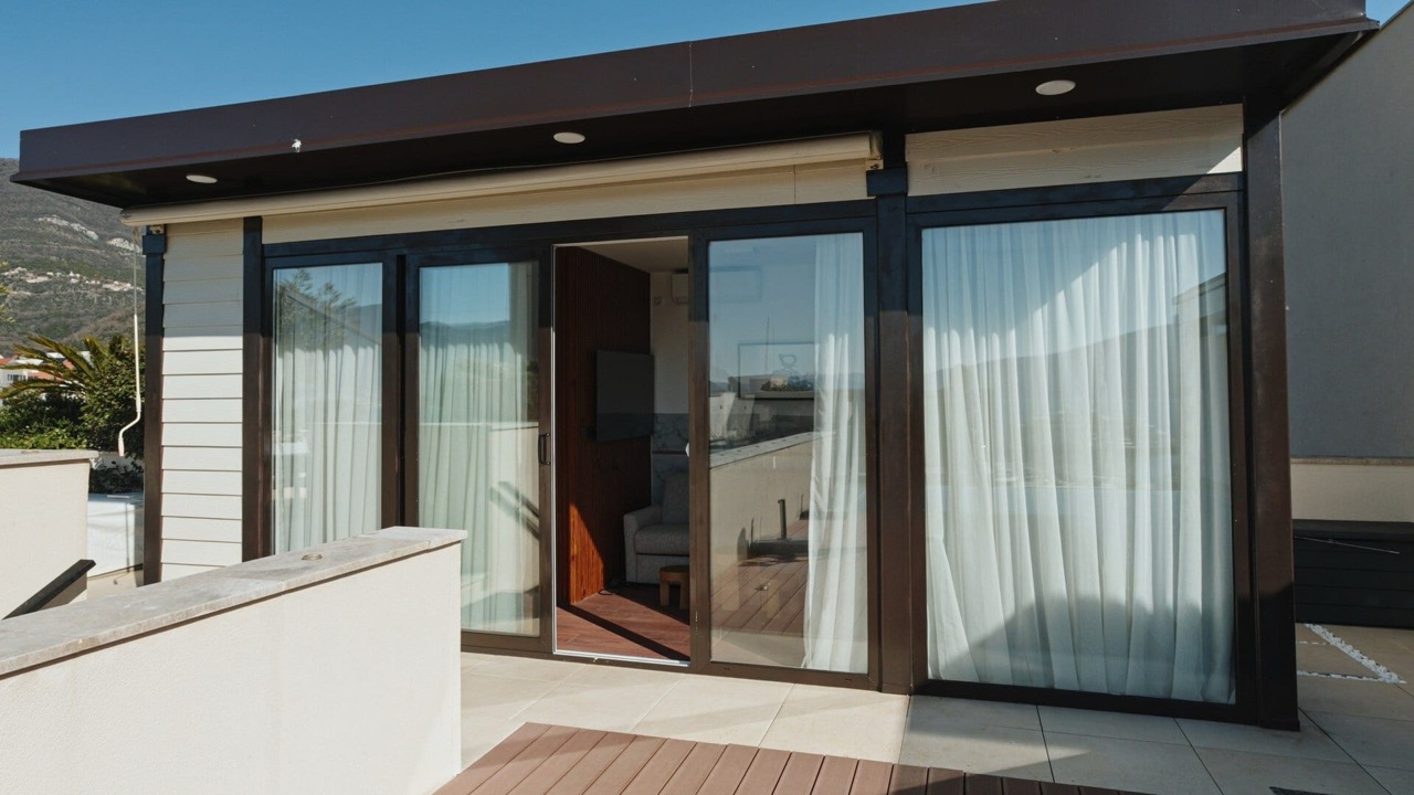 Terrace with panoramic windows and mountain views in an apartment in Porto Montenegro, Tivat, Montenegro.