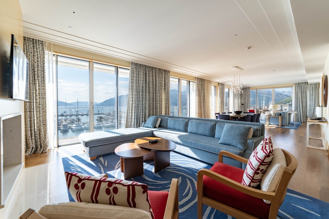 Living room with panoramic views of the marina in a luxury apartment, Tivat, Montenegro: stylish furniture and a modern interior.