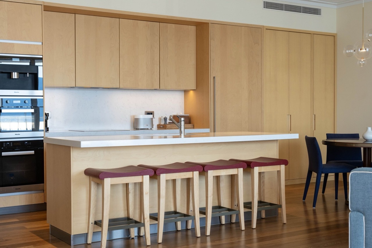 Modern kitchen with wooden fronts and a bar counter in an apartment in Tivat, Montenegro.