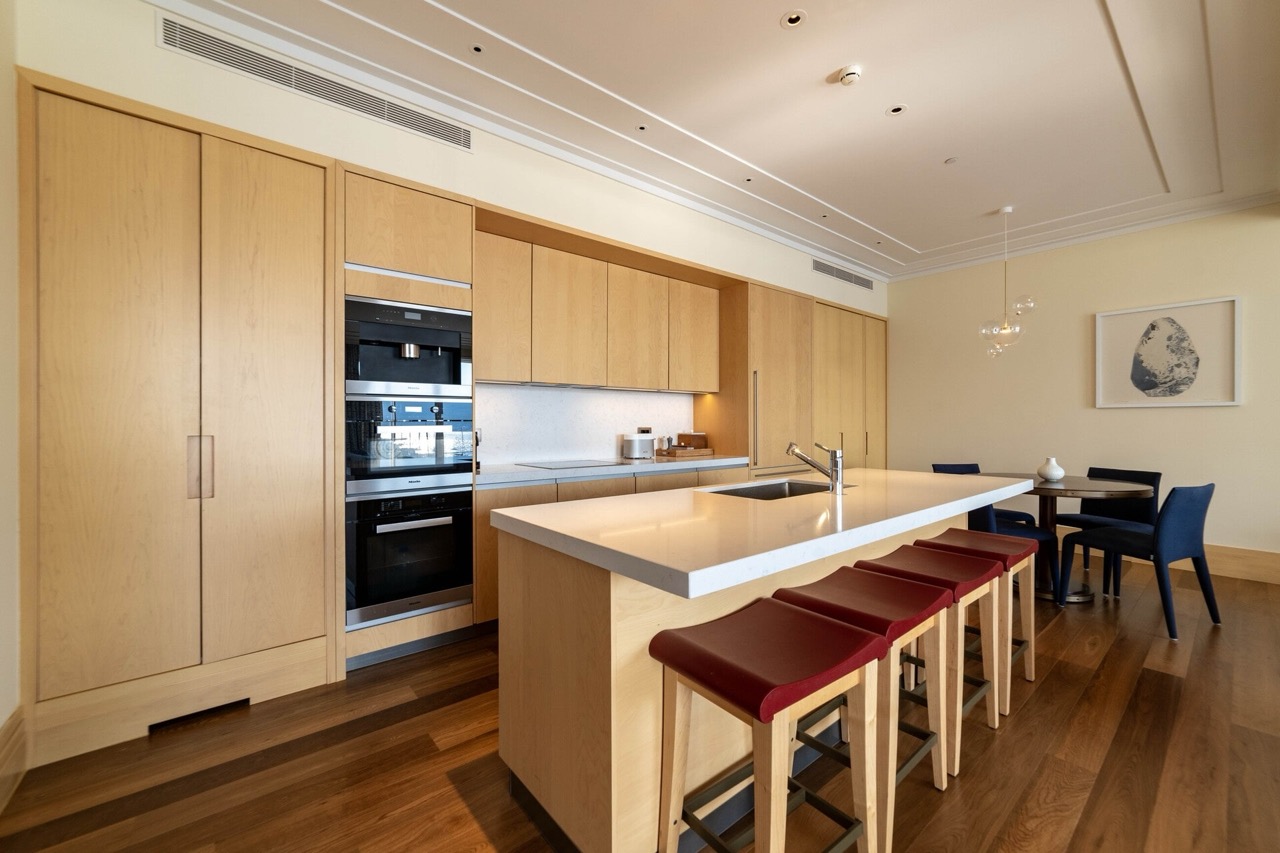 Modern kitchen with wooden fronts and an island in a luxury apartment, Tivat, Montenegro.