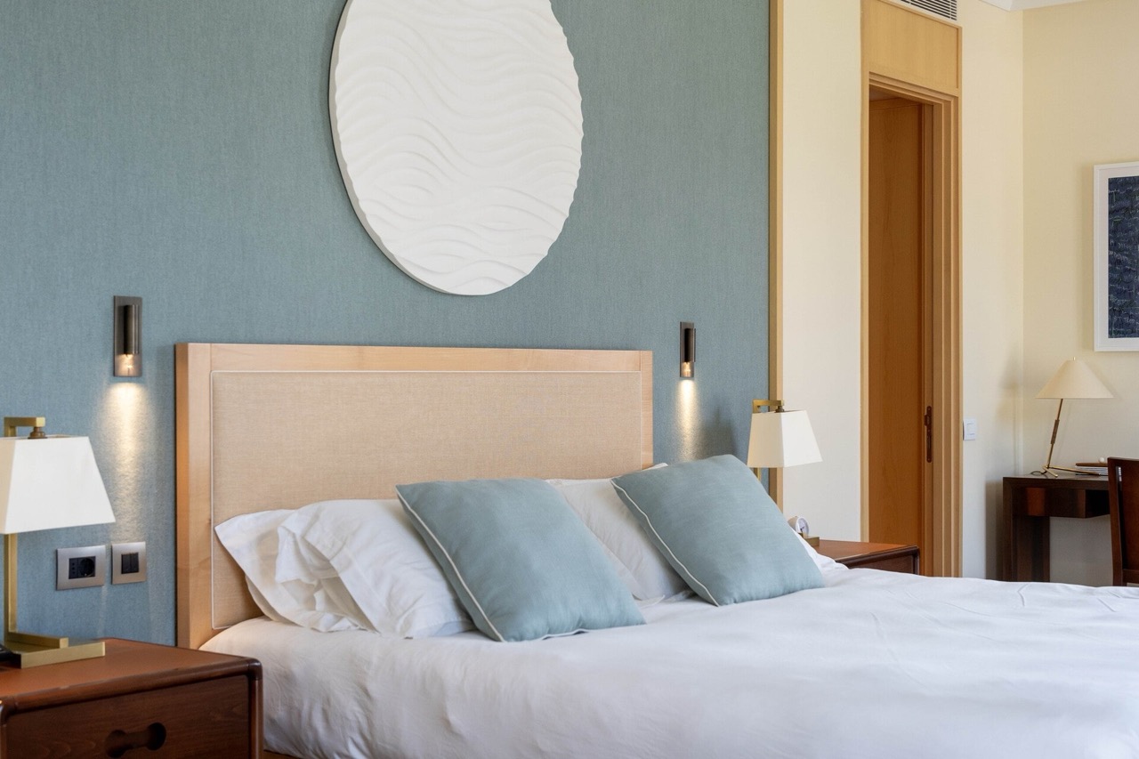 Modern bedroom in an apartment in Tivat, Montenegro: a double bed, stylish decor, and wooden furniture.