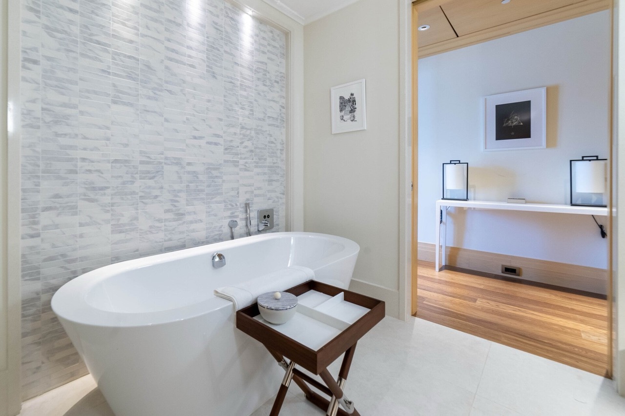 Modern bathroom with a freestanding bathtub and marble tiles in a luxury apartment, Tivat, Montenegro.
