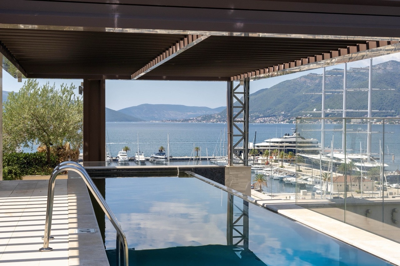 Pool on the terrace of a luxury apartment in Tivat, Montenegro, with panoramic views of the marina and yachts of Porto Montenegro.