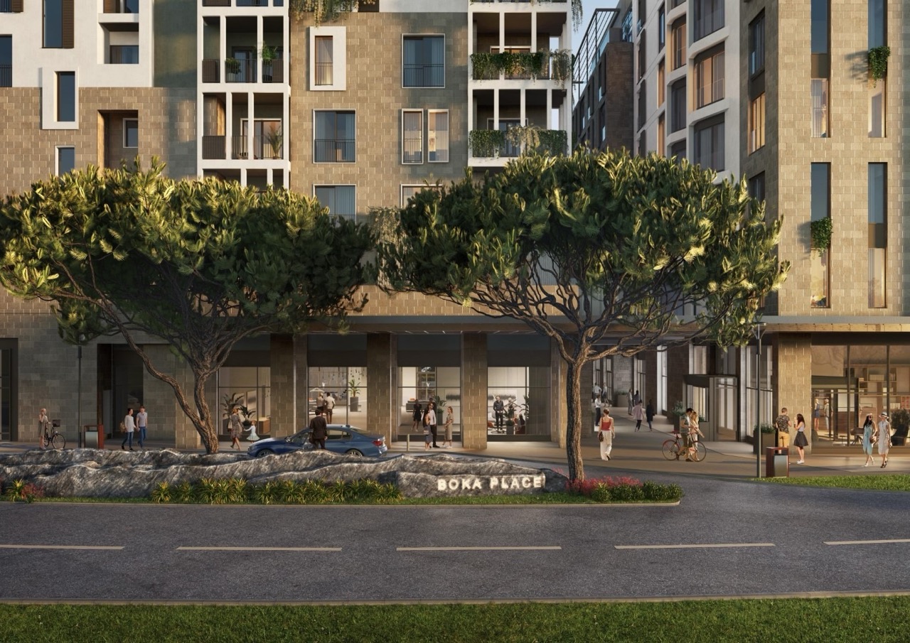 Facade of the modern Boka Place residential complex in Porto Montenegro, Tivat, Montenegro, with landscaped grounds.