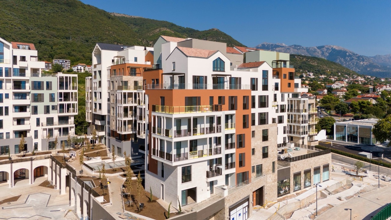 Modern residential complex in Porto Montenegro, Tivat, Montenegro: exterior view of multi-story buildings with terraces.