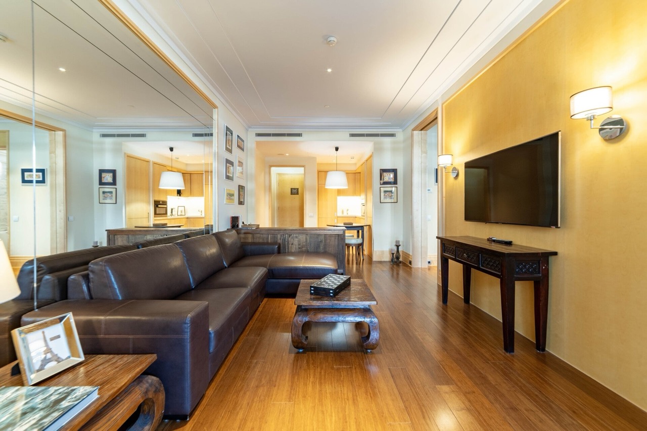 Living room with a leather sofa and wooden furniture in an apartment in the Porto Montenegro complex, Tivat, Montenegro.